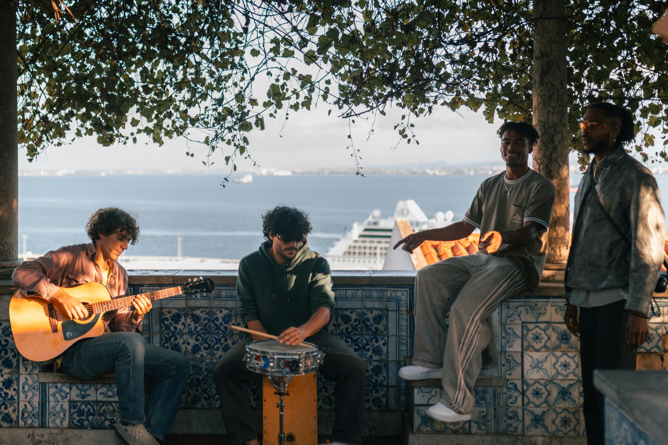 Musicians writing and playing outdoors Musicians writing and playing acoustic guitar and percussion outdoors